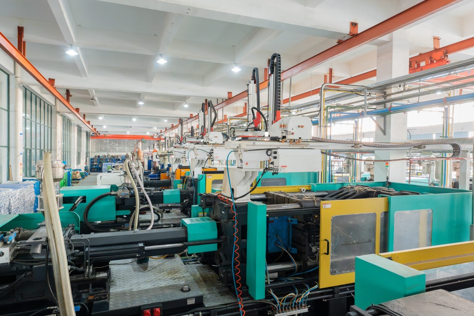 Injection moulding workshop with rows of production machines